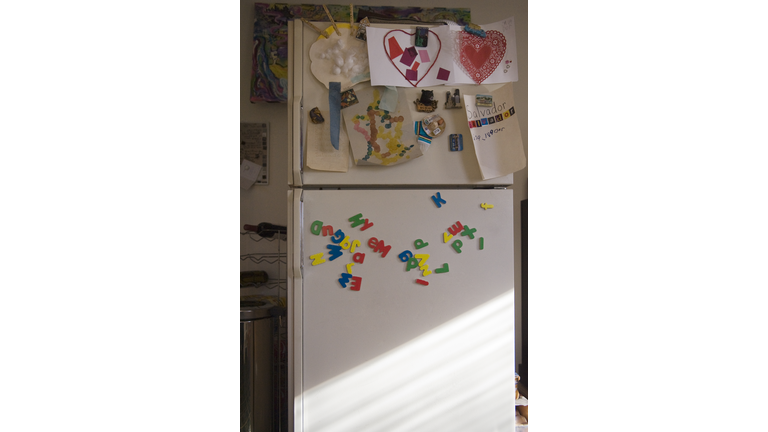 Refrigerator door with child's school art projects