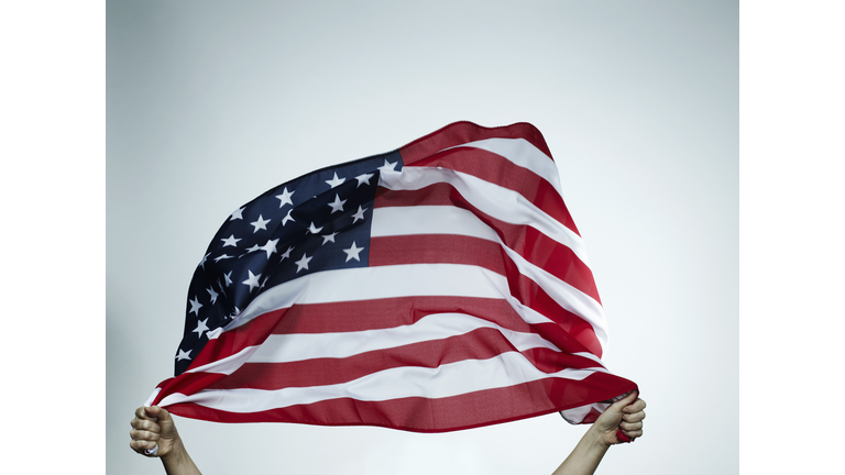 Hands holding American flag