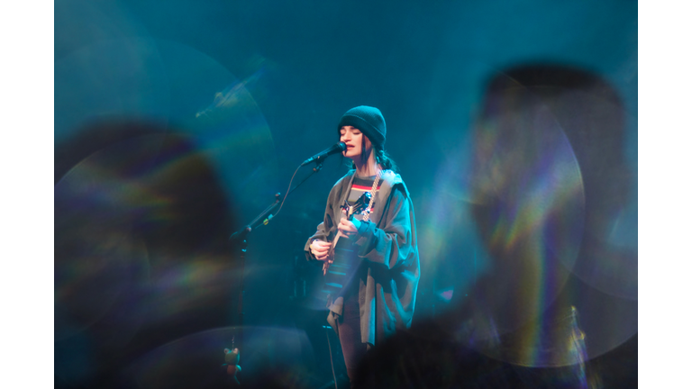 crowd shot of singer with guitar