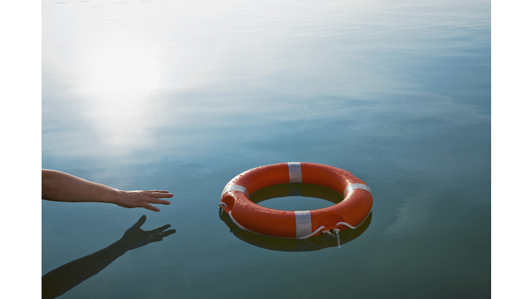 Someone reaching out for a life-ring 