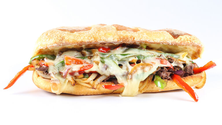 Tasty beef steak sandwich with onions, mushroom and melted provolone