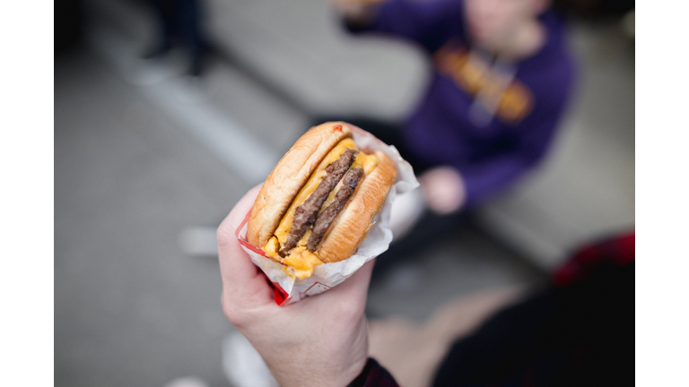 Cropped hand of person holding burger,San Francisco,California,United States,USA