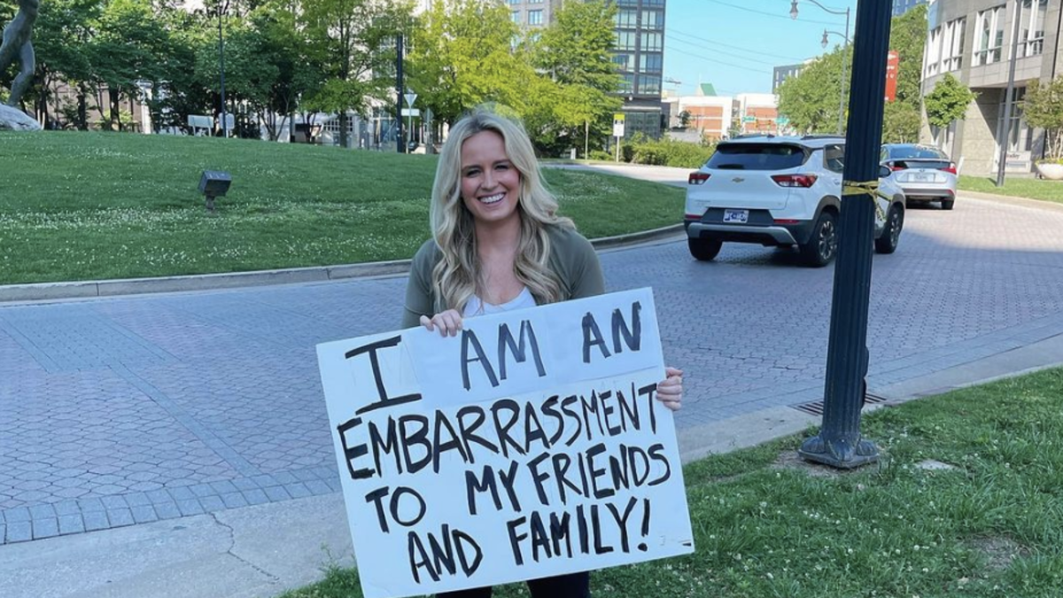 Stands on Street With Sign as Punishment After State Capitals