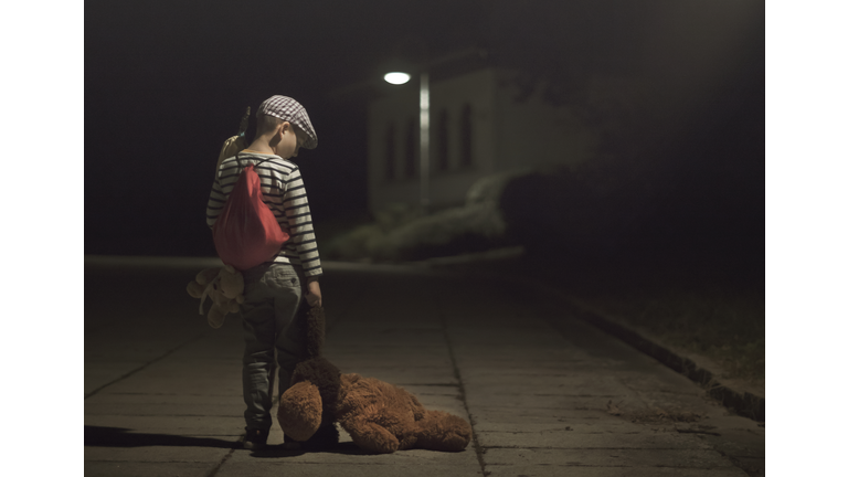 Little Runaway kid with sack luggage and Teddy Bear