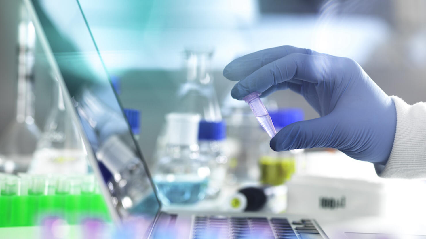 Research experiment, scientist examining vial containing sample used in biomedical, DNA, biotechnology, analytical chemistry and pharmaceutical research