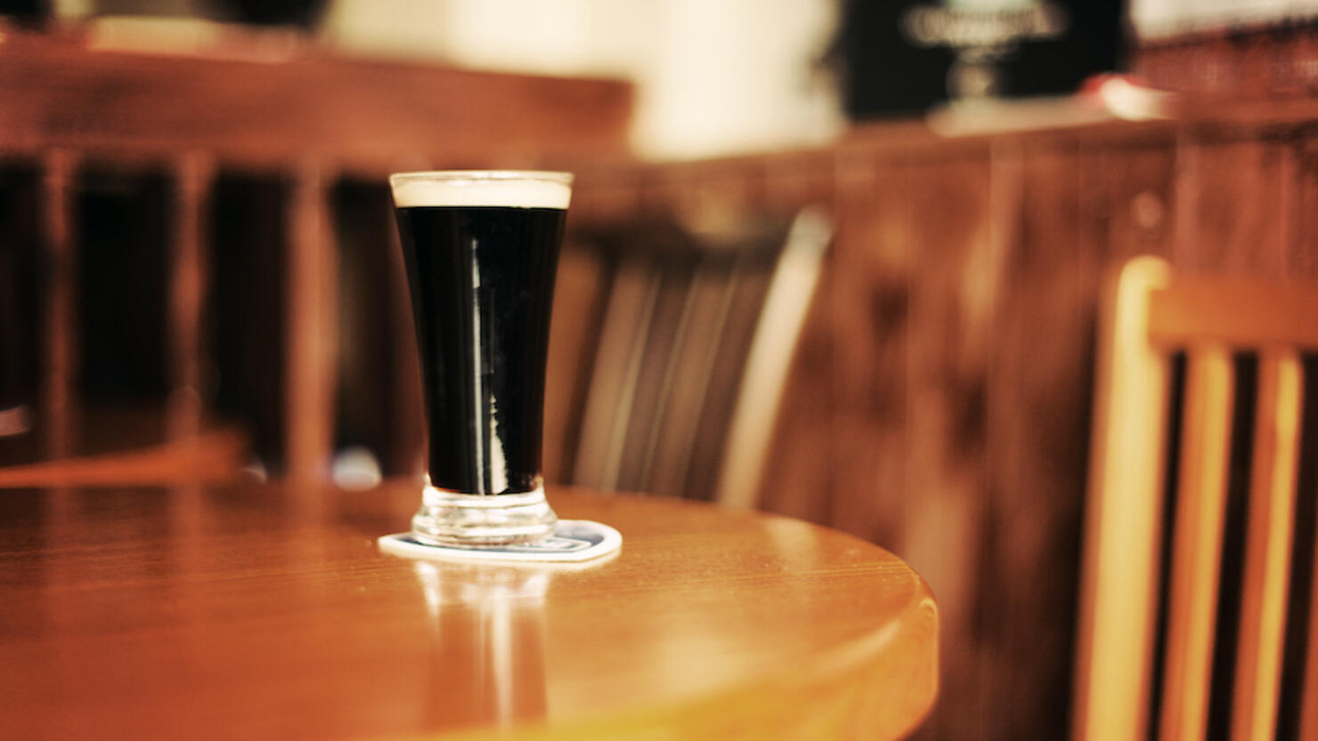 Glass of Guinness on pub table