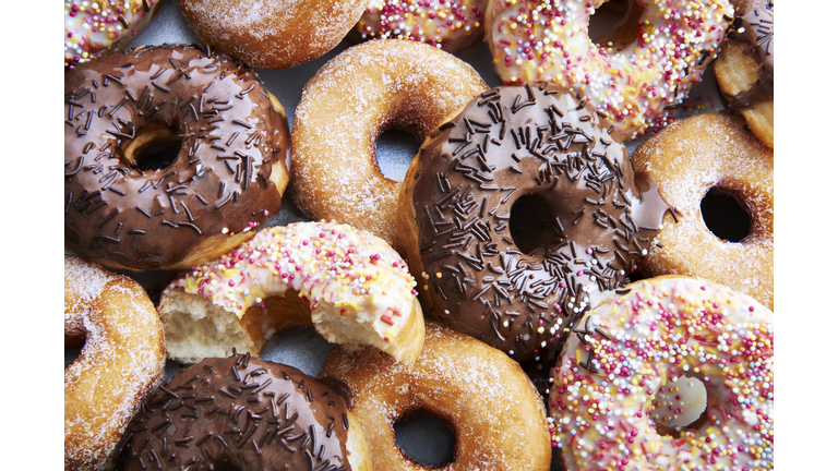 Ring doughnuts covered in icing and sprinkes