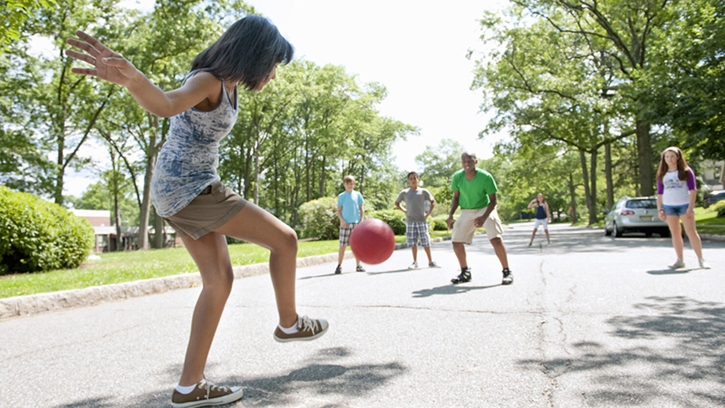 Kids Playing Kickball in a Suburban Neighborhood