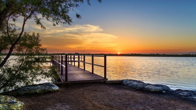 Pier on a small lake at sunset