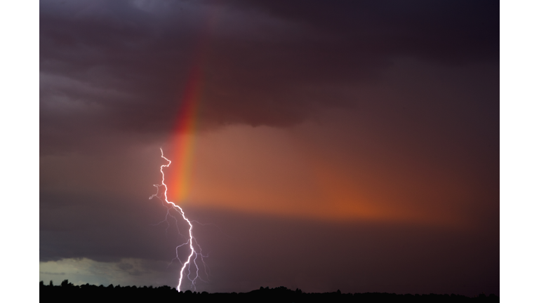 Lightning and rainbow at sunset