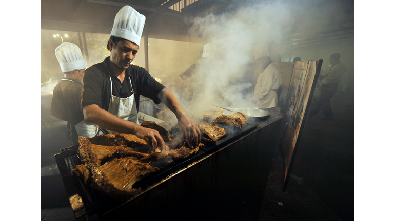 A Pakistani chef grills mutton ribs at a