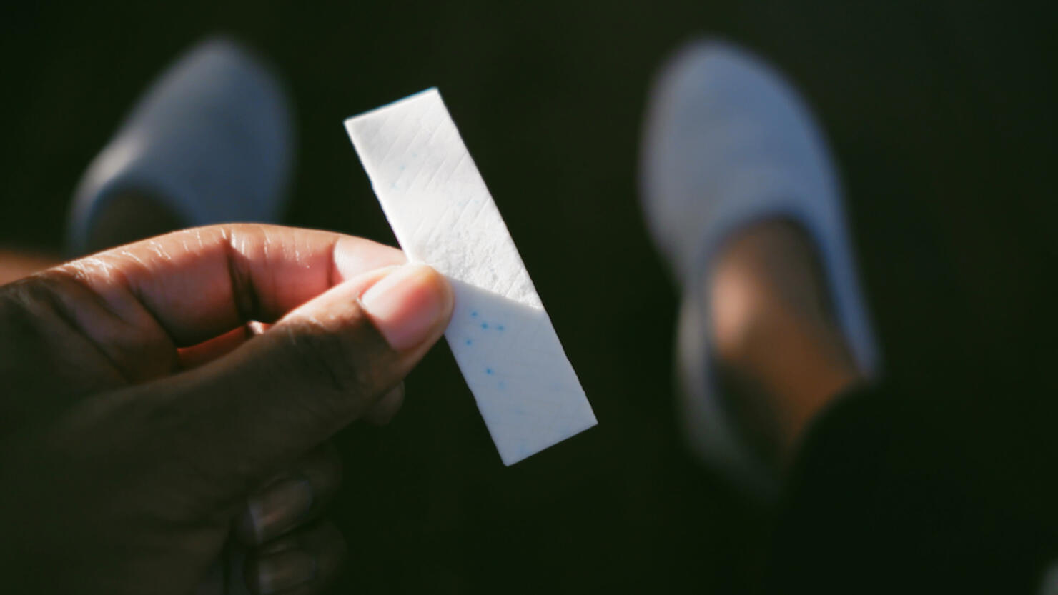 Woman Holds Stick of Gum