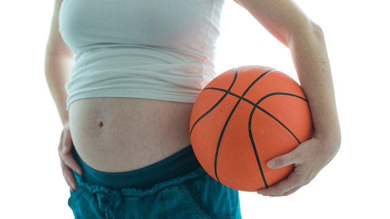 Pregnant woman with basketball