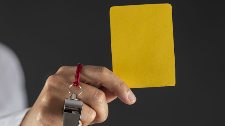 Woman Holding Yellow Card
