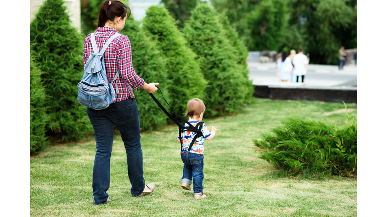 Mom insures her child during a walk