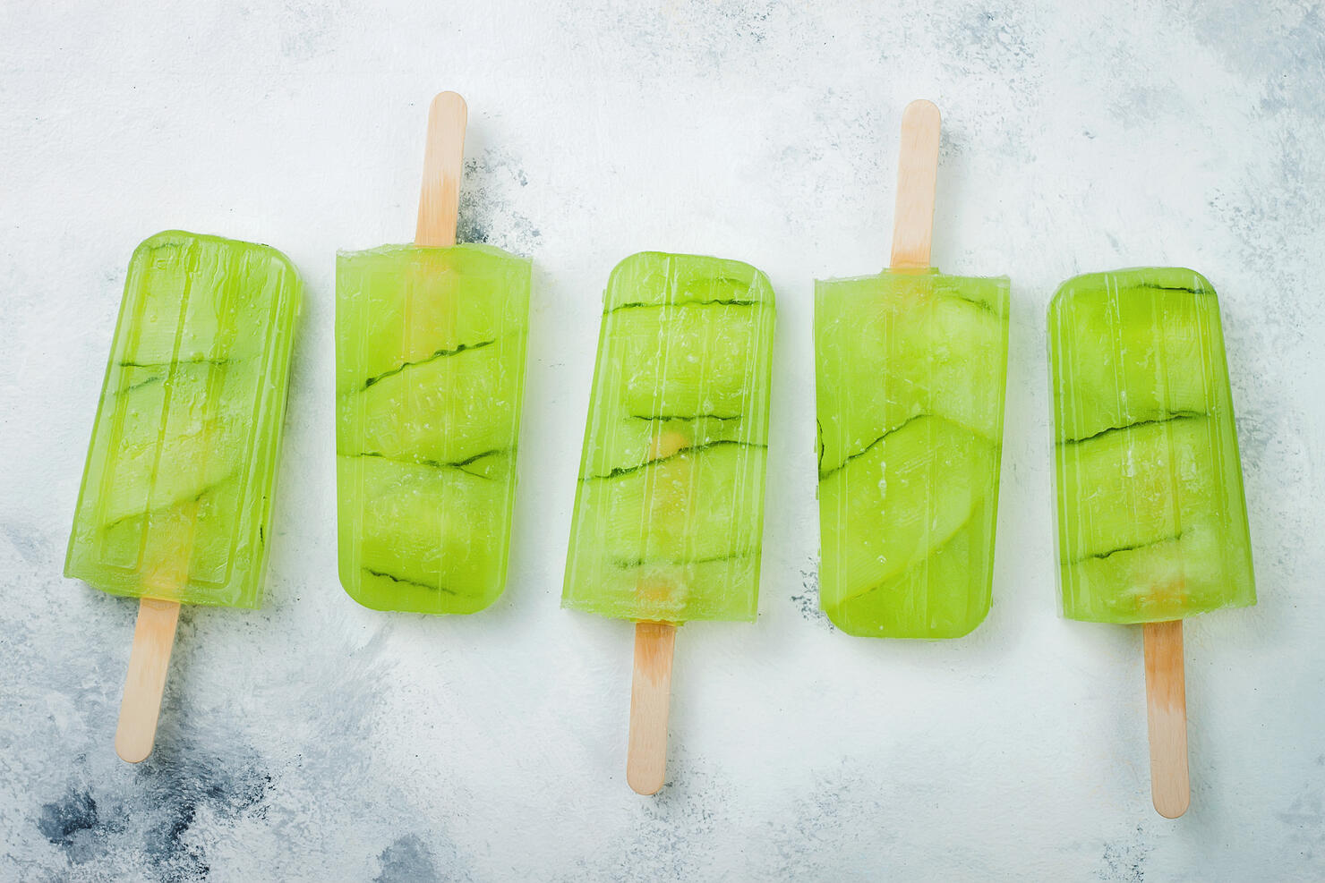Detox cucumber lemon juice popsicles with white currant. Top view, overhead.