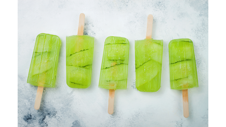 Detox cucumber lemon juice popsicles with white currant. Top view, overhead.