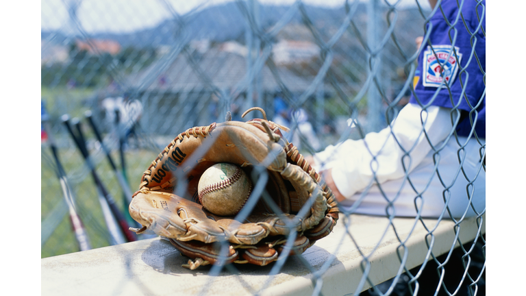 Sportsman by mitt and baseball, rear view