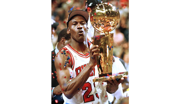 Michael Jordan of the Chicago Bulls holds the Larr