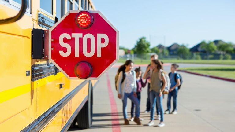 Children feel safe with bus warning sign out and flashing