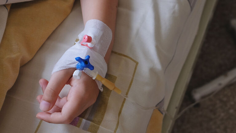 Child's hand with IV drip attached