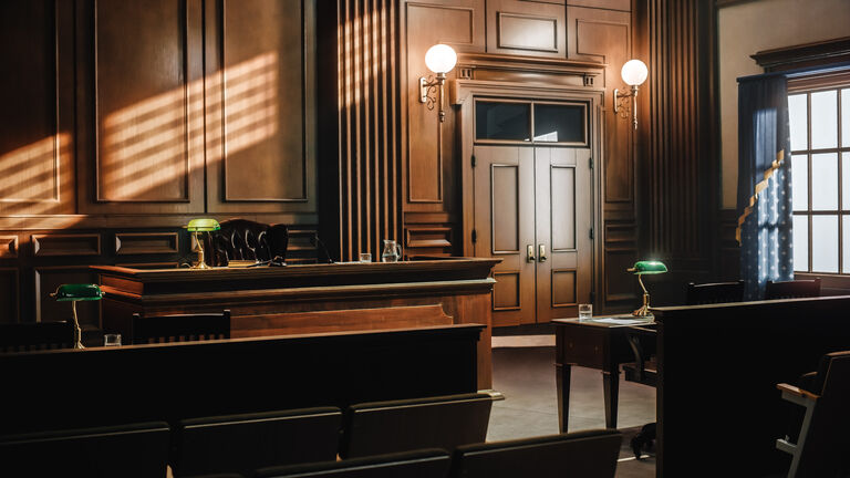 Empty American Style Courtroom. Supreme Court of Law and Justice Trial Stand. Courthouse Before Civil Case Hearing Starts. Grand Wooden Interior with Judge's Bench, Defendant's and Plaintiff's Tables.