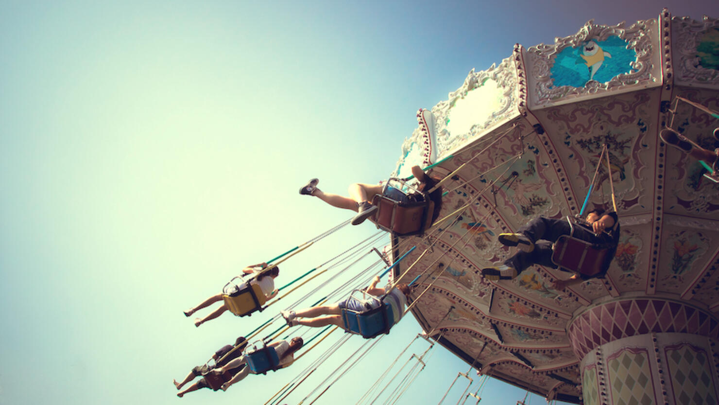 People playing swing carousel in amusement park