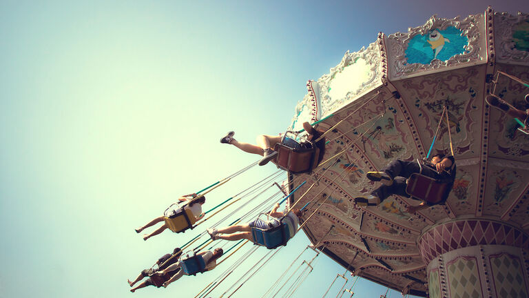 People playing swing carousel in amusement park