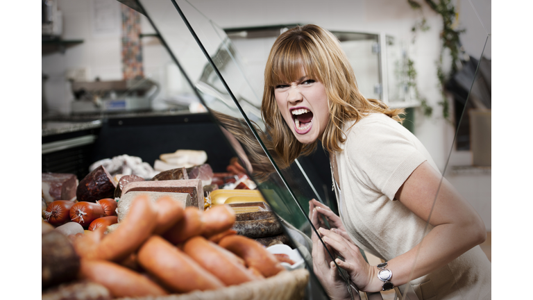 Wild young woman in butchers shop