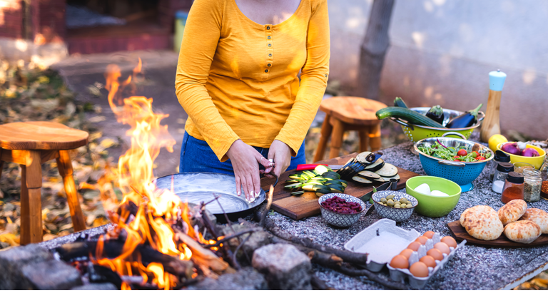 Woman prepares cooking pan for healthy ingredients