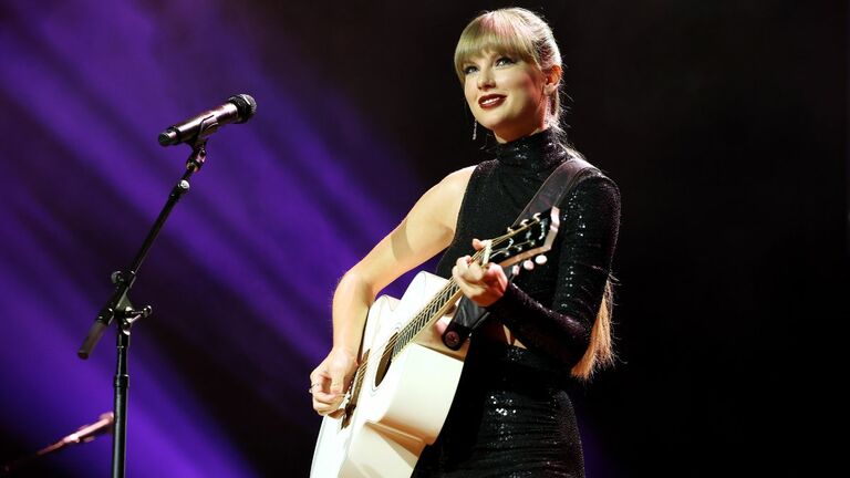 Taylor Swift Receives One of Her First Guitars in “Christmas Tree Farm”  Music Video
