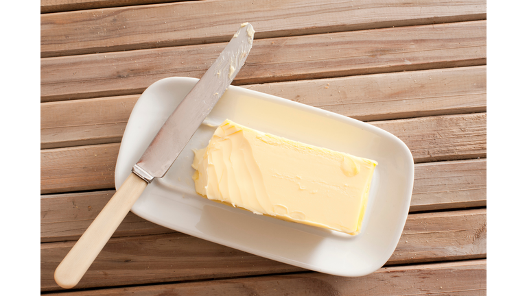 Directly Above Shot Of Butter And Knife On Wooden Table