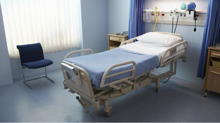 Empty Hospital Bed in a Ward