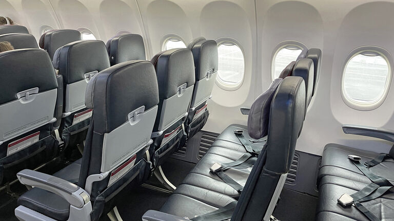 Rows of empty seats in airplane cabin, COVID 19, coronavirus pandemic