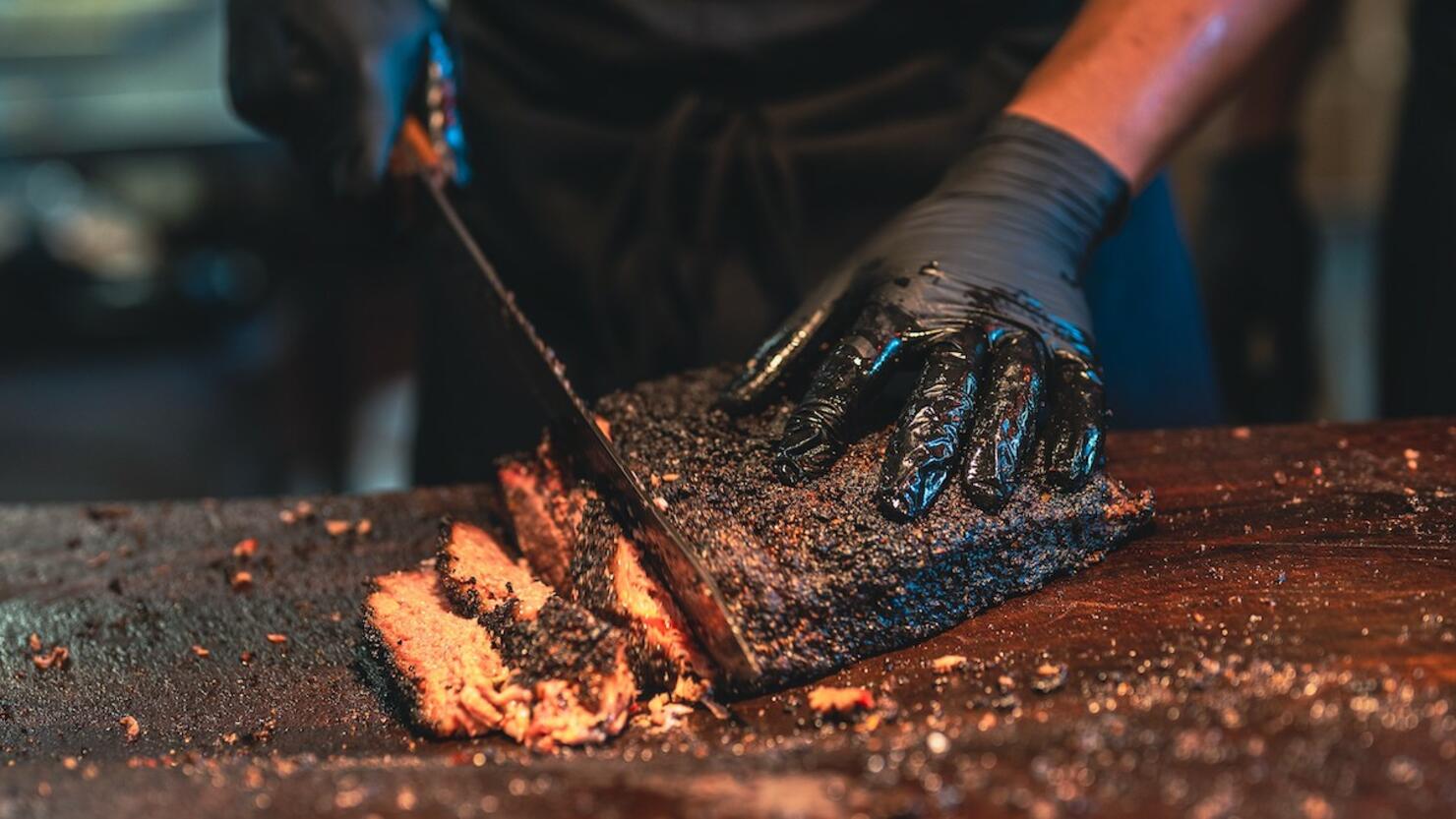 BBQ Chef Cuts Deliciously Tender Smoked Brisket Slices.