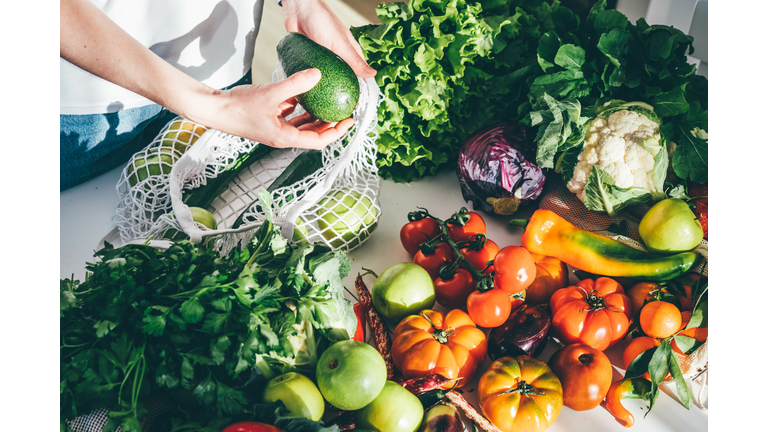 woman takes fresh organic vegetables