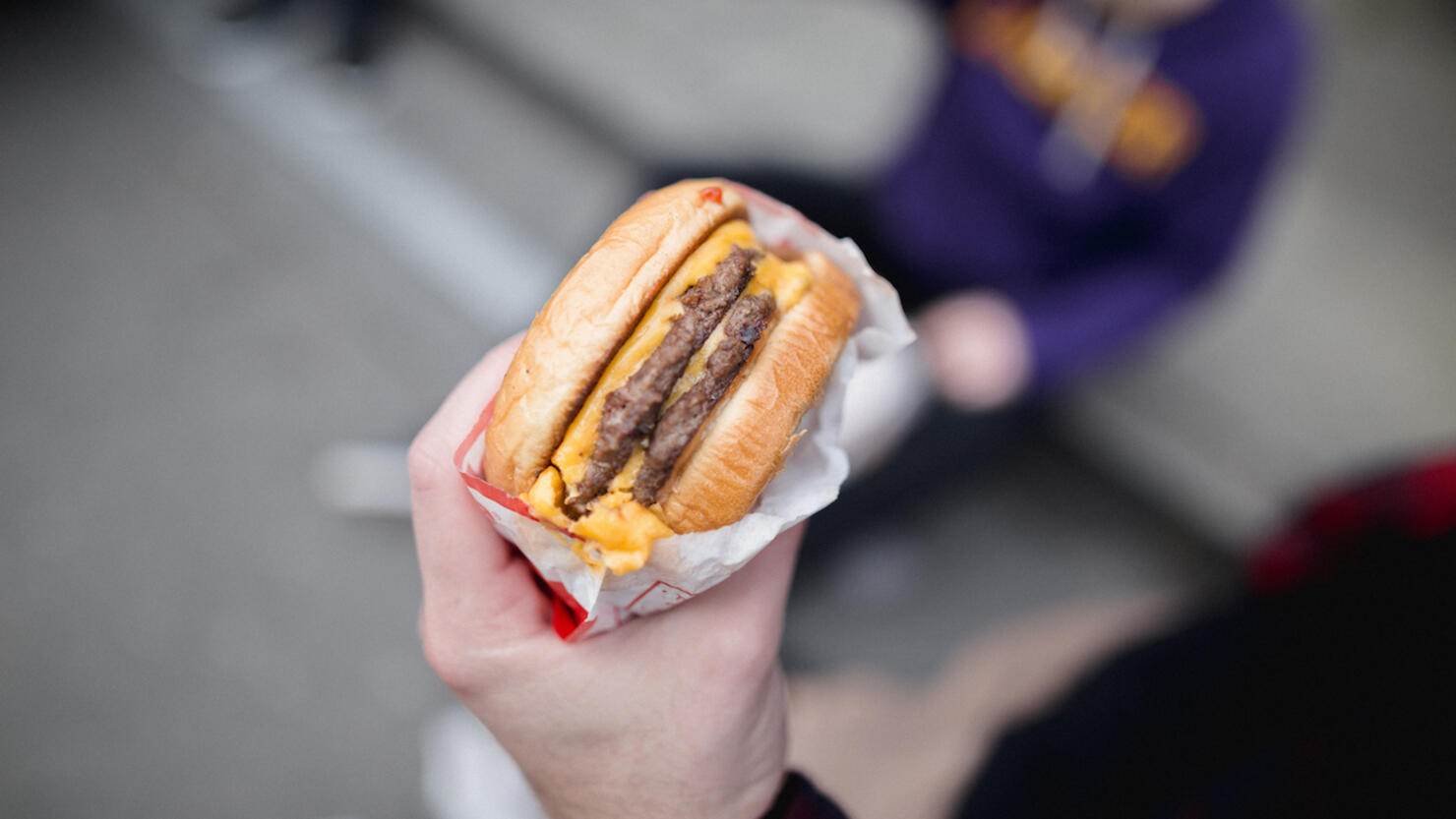 Cropped hand of person holding burger,San Francisco,California,United States,USA