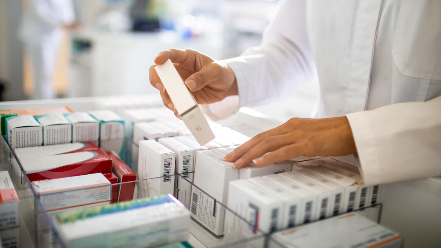 Pharmacist organizing the medicine drawer