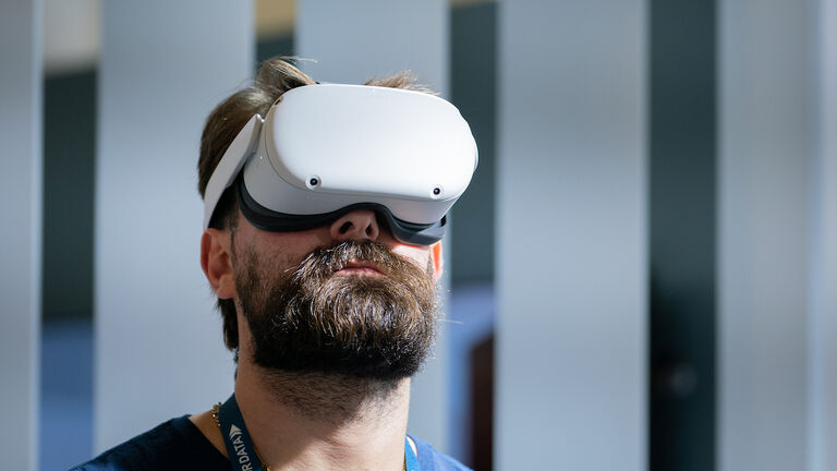 A man wears an Oculus VR Inc virtual reality (VR) headset at