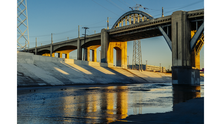 Sunlight on Los Angeles river embankment and 6th street bridge, Los Angeles, California, USA