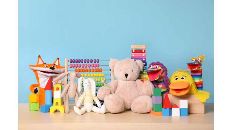 Collection of different toys on wooden table