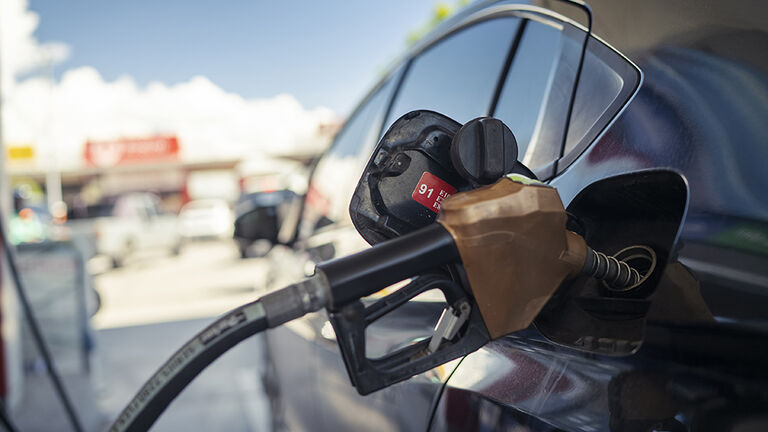 Car at the gas pump being filled with gas