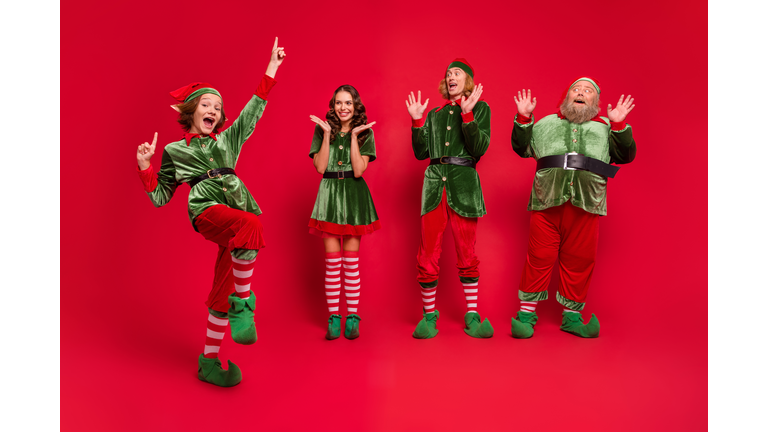 Full body photo of astonished santa family yell wear new year costumes isolated on red color background