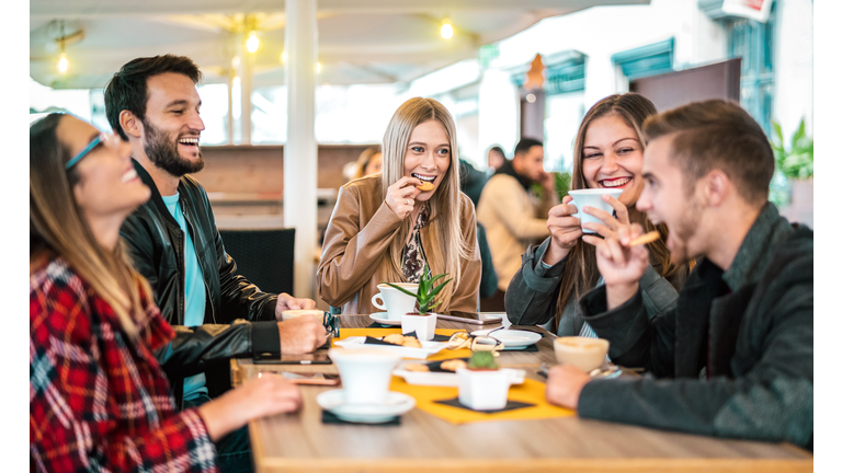 Friends group drinking cappuccino at coffee bar - People talking and having fun together at fancy cafeteria - Friendship concept with happy guys and girls at restaurant cafe - Warm bulb light filter