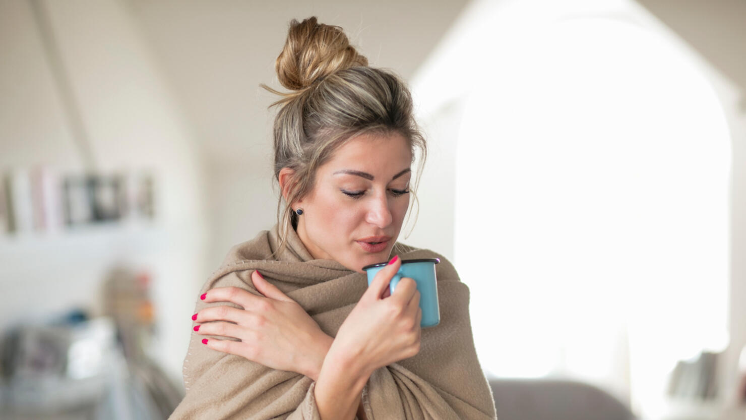 Woman Wrapped Having Drink While Standing At Home