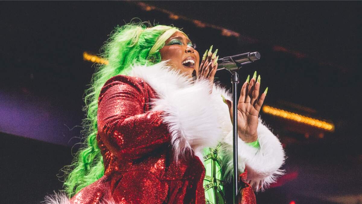 Lizzo dazzles in sparkling sexy leotard wrapped in festive red bow at  iHeartRadio Jingle Ball concert