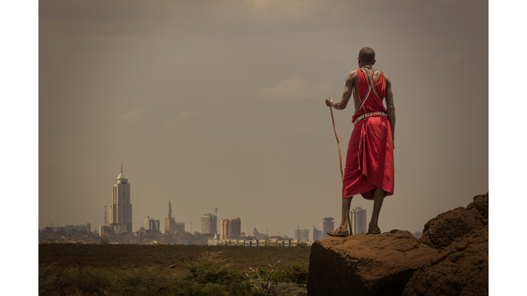 Masai man with traditional dress watching Nairobis skyline, Nairobi, Nairobi Area, Kenya