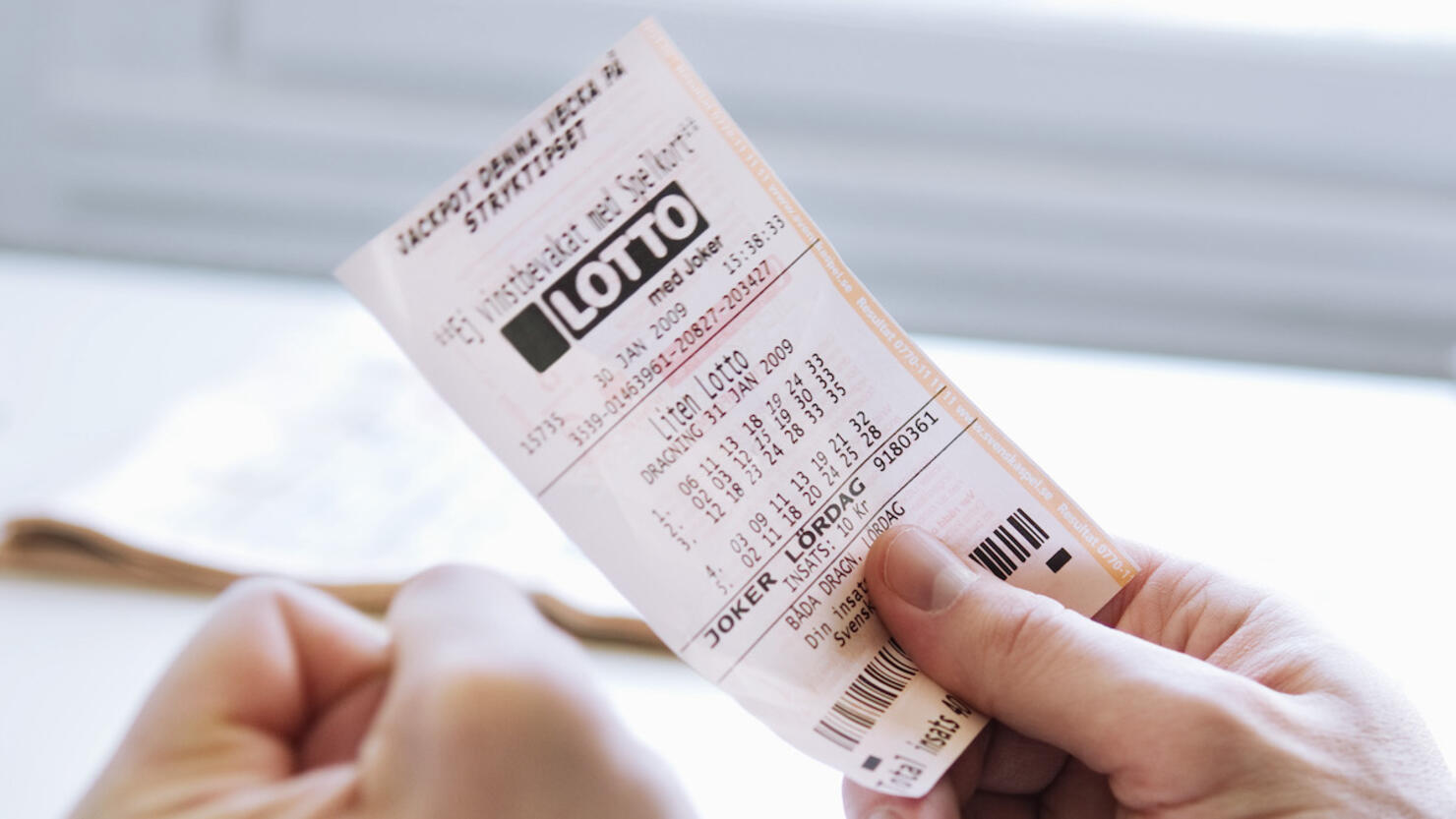 Man with lottery ticket