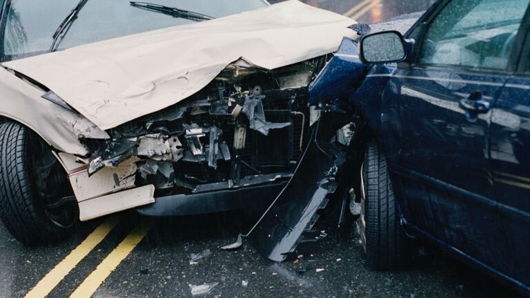 Two damaged cars after crash, close-up