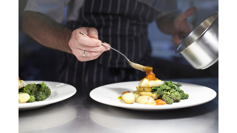 Chef preparing dish in kitchen